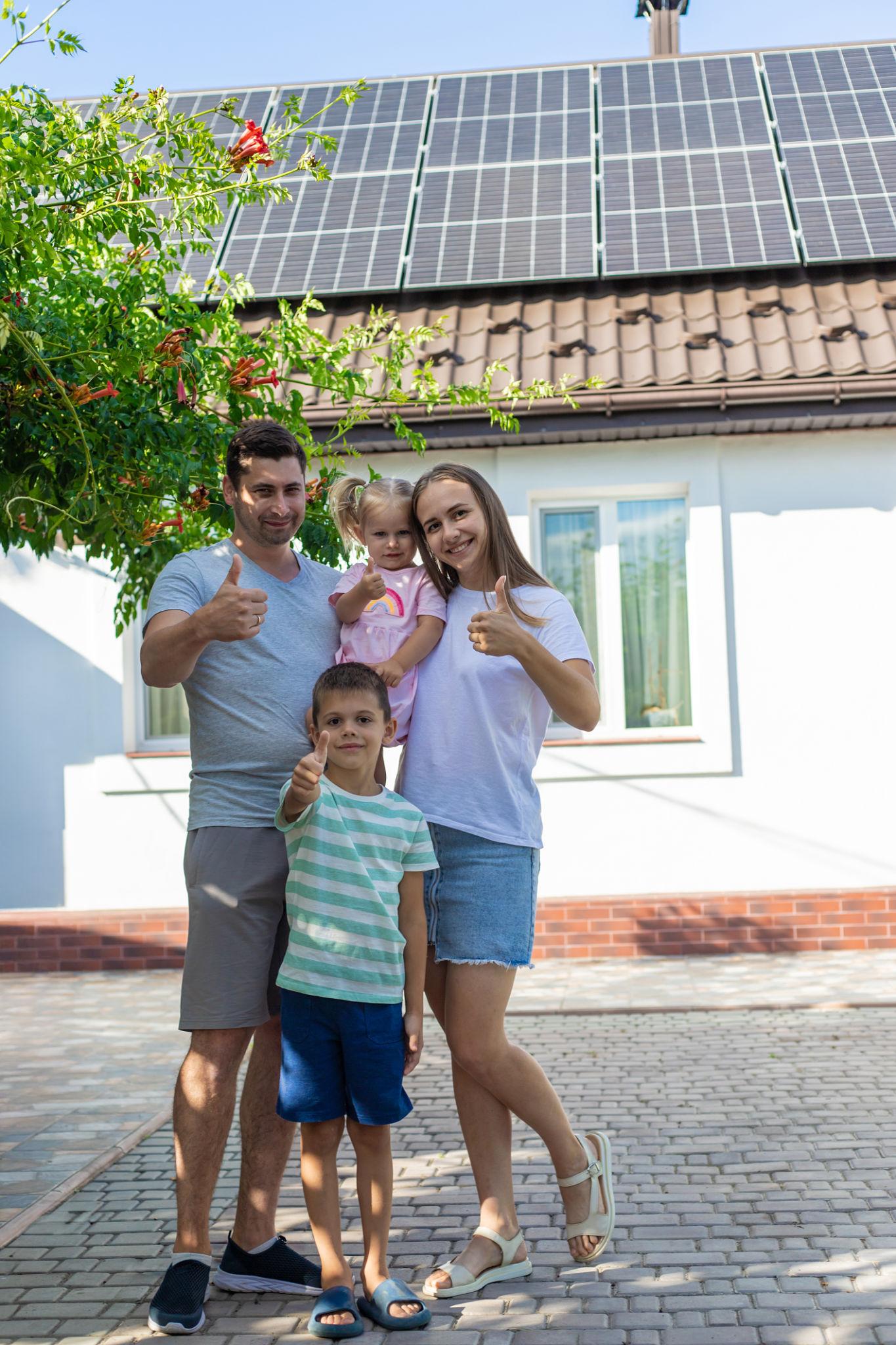 Happy Family with Solar panels on the roof